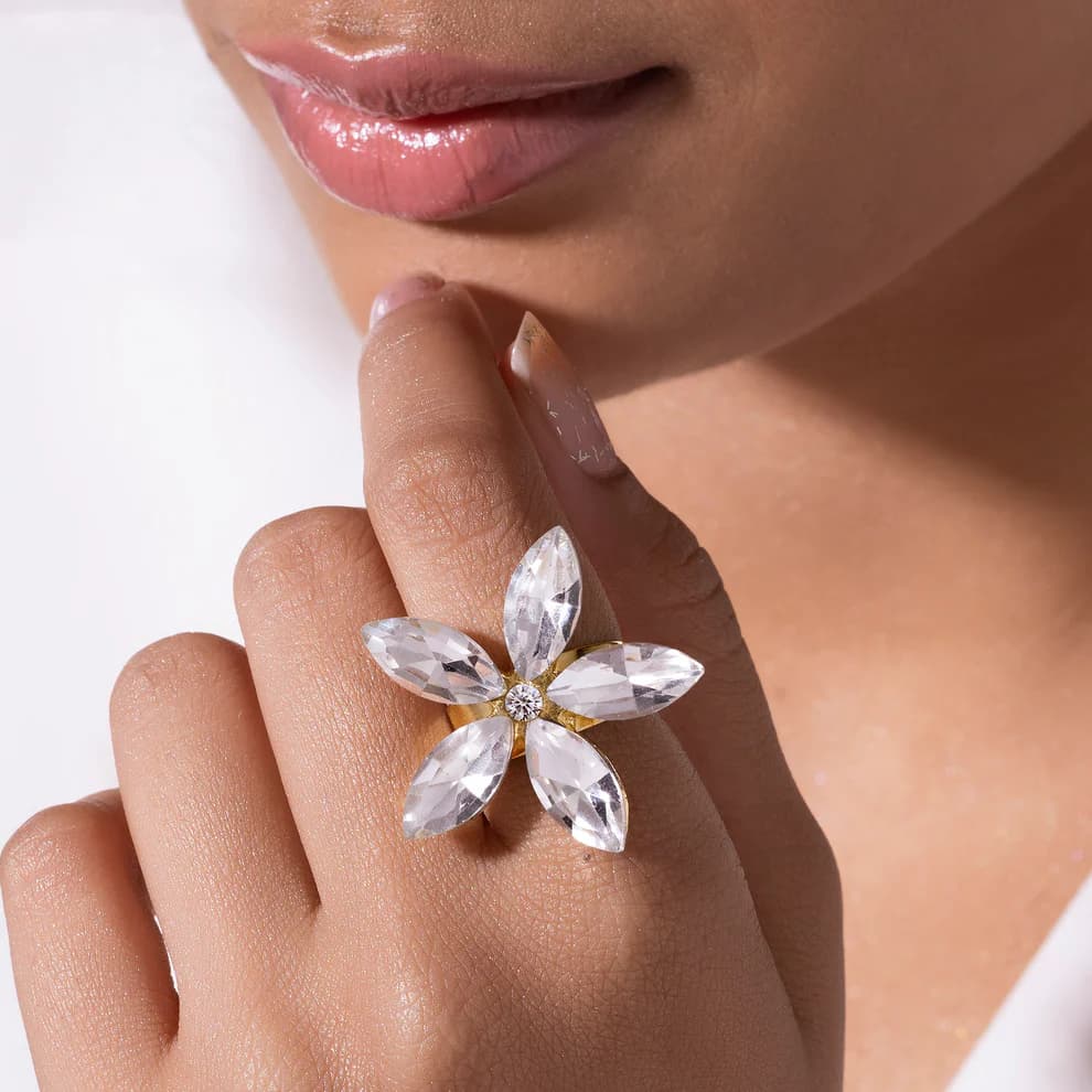 Crystal flower cocktail ring from Ushve worn on a model's hand